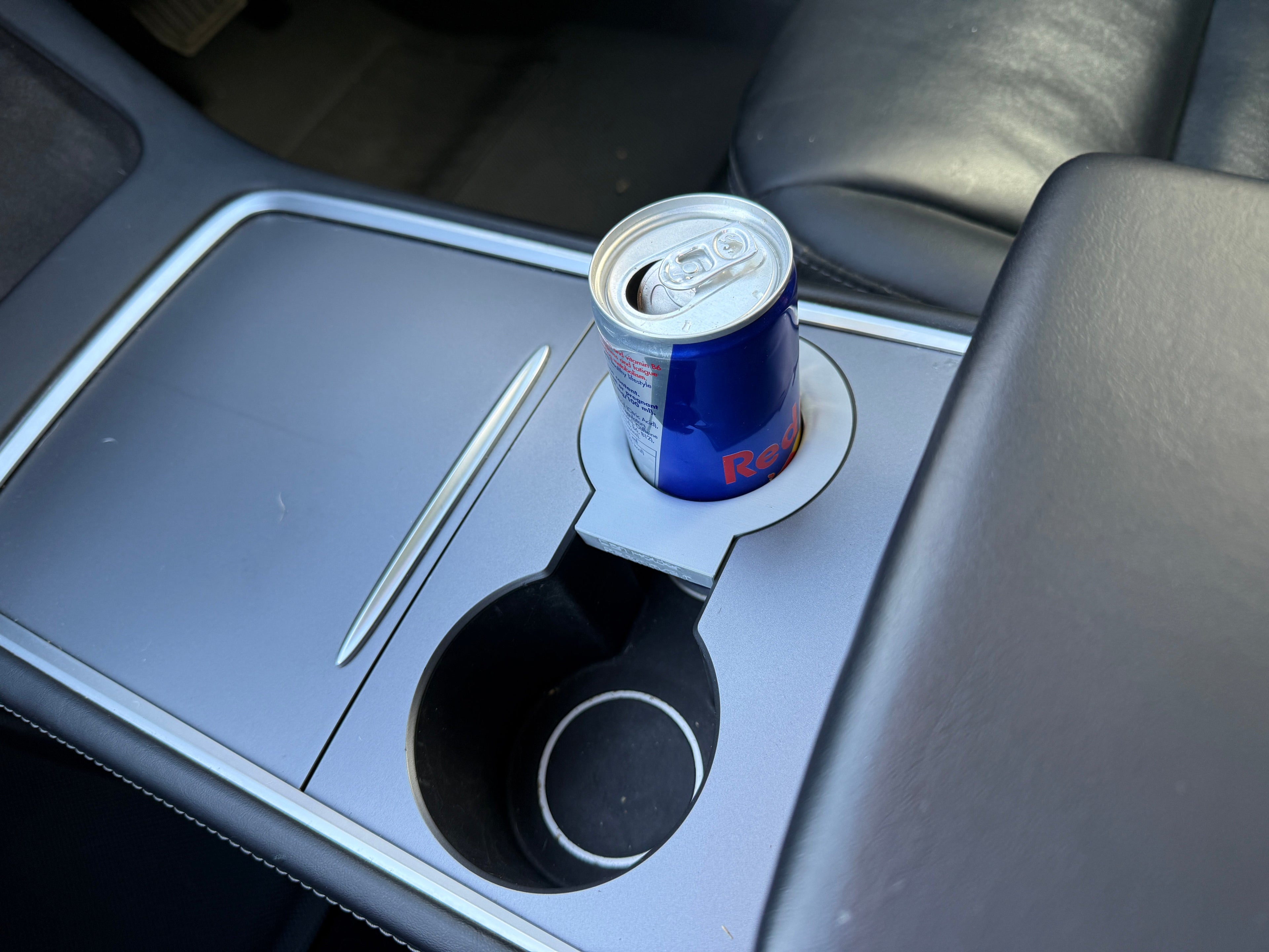 Red Bull can in a car's cup holder
